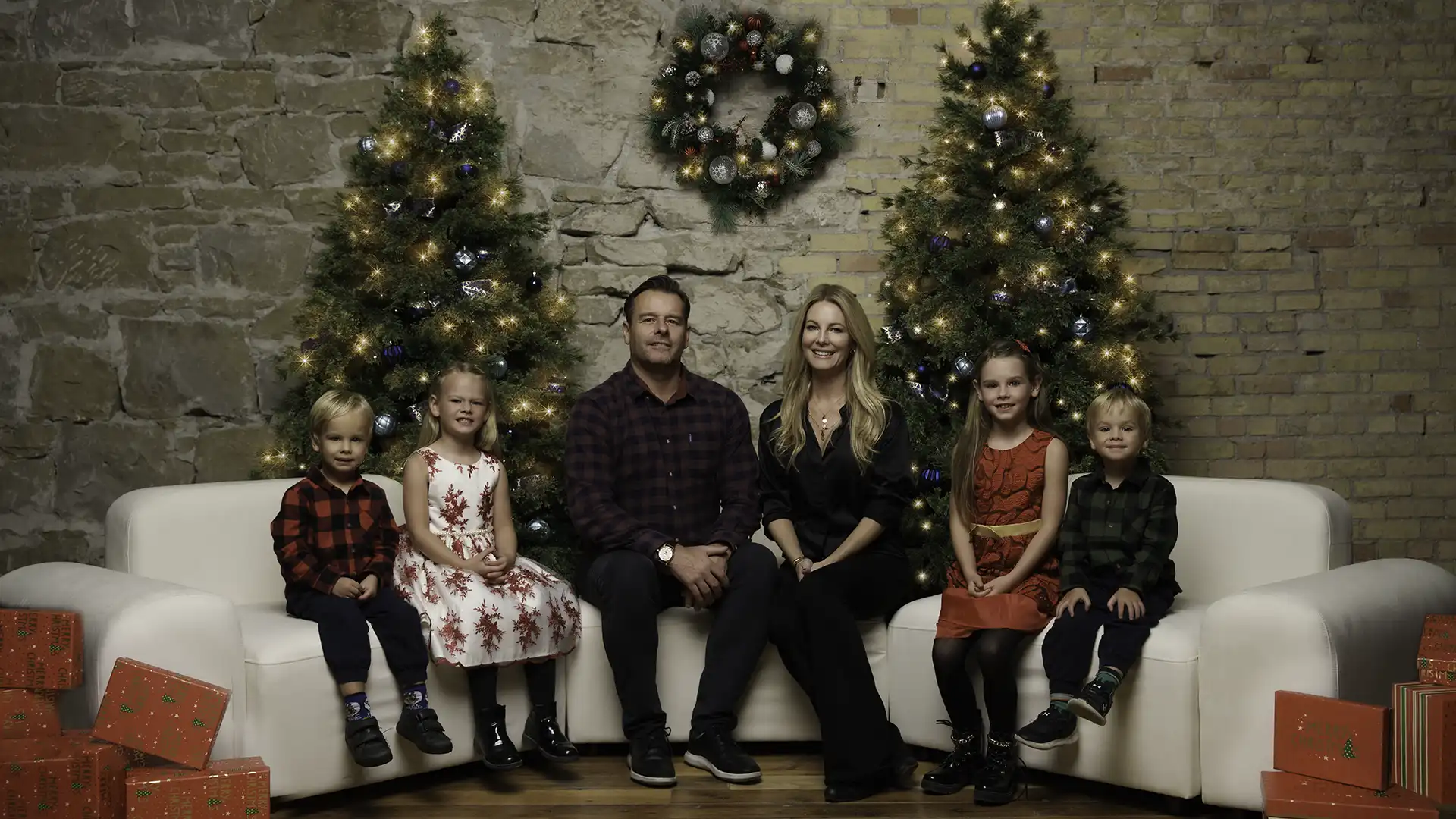 family posing on sofa for Christmas portrait - Calgary holiday sessions