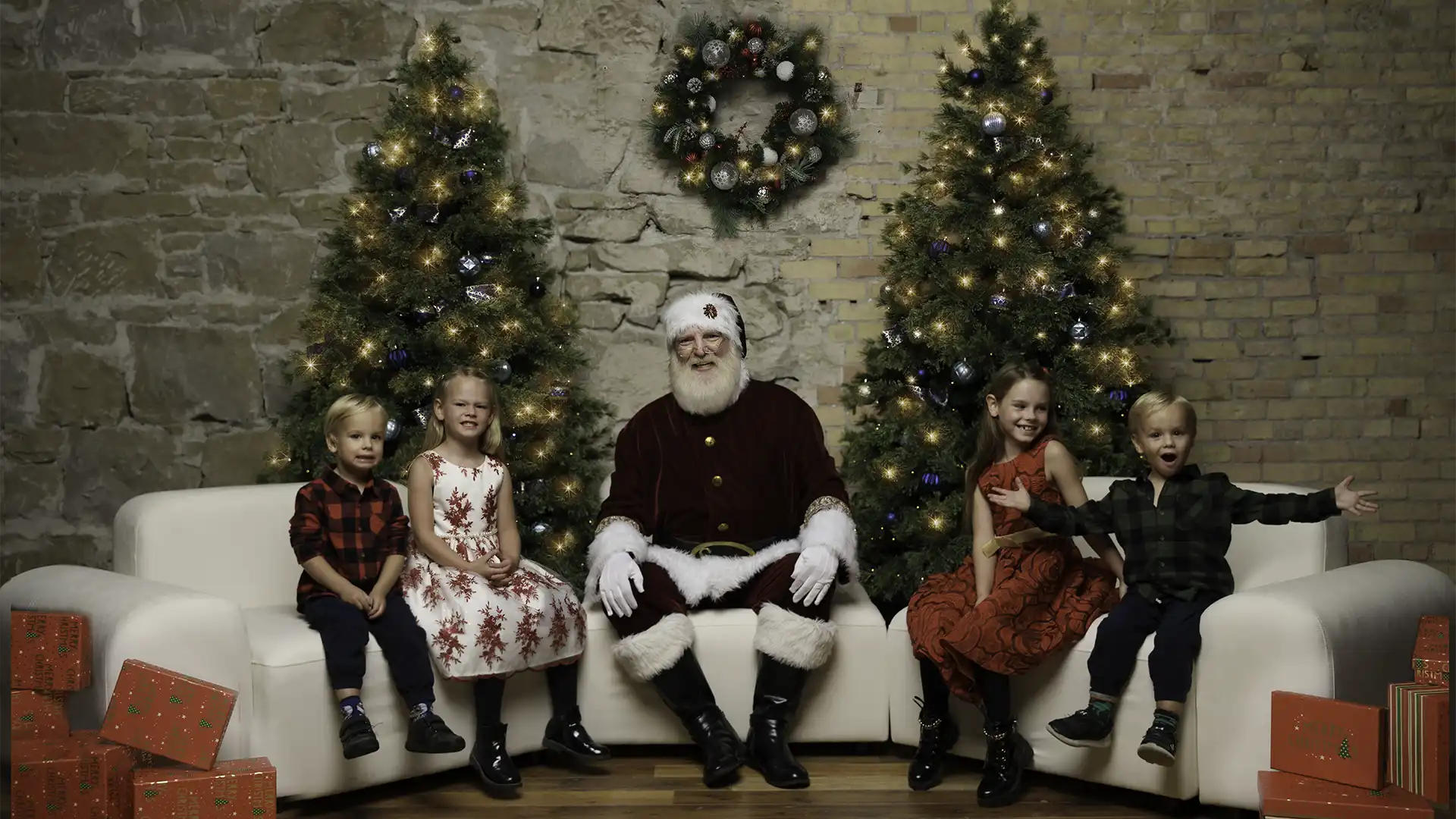 kids posing with Santa on sofa - Calgary Santa sessions